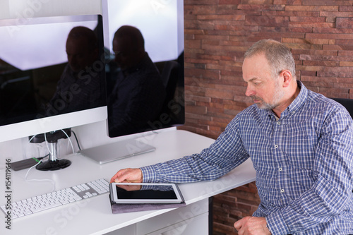 Senior man working in the office photo