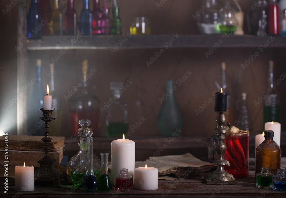 Magic potion, ancient books and candles Magic potion, ancient books and candles