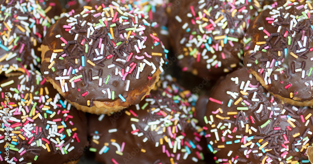 Donuts in chocolate with sprinkles Donuts in chocolate with sprinkles