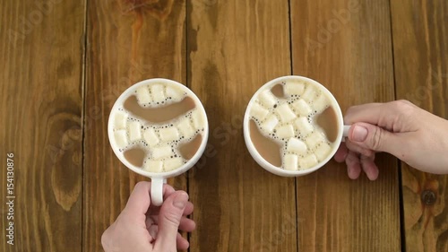 Two coffee cups on a wooden table