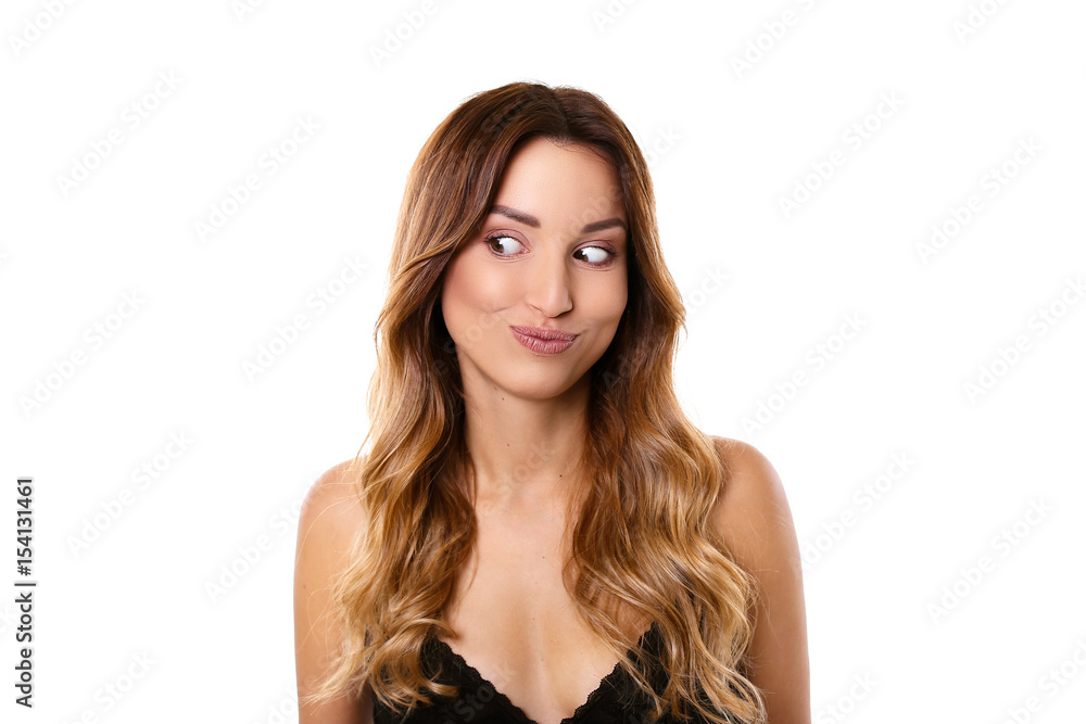 Very interesting! Attractive young woman smiling looking to the side standing on a white background Very interesting! Attractive young woman smiling looking to the side standing on a white background