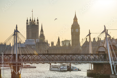 Big Ben and Golden Jubilee Bridges at sunset in London