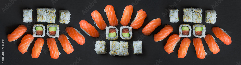 Salmon sushi and roll sushi on black
