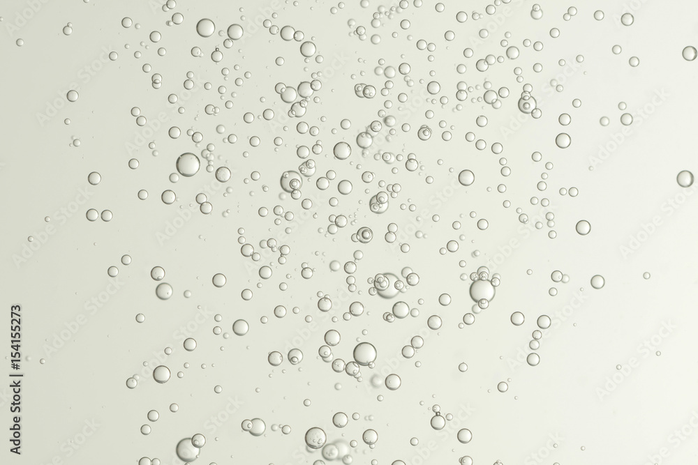Many small fizz bubbles flows in a wine glass