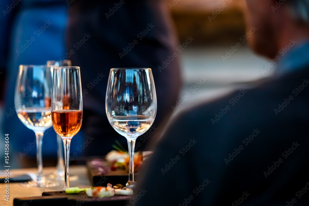 Silhouettes of people sitting at a table in the restaurant. On the table plates glasses. Silhouettes of people sitting at a table in the restaurant. On the table plates glasses.