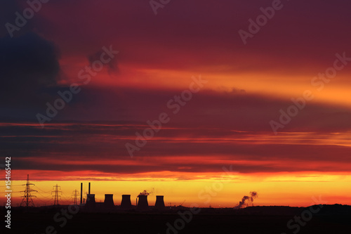 Silhouette of a power station as sunset