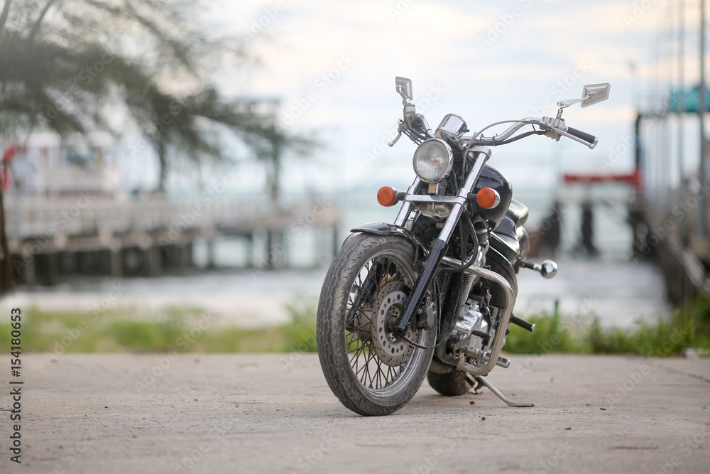 Obraz premium Motorcycle on the road at the sea ferry pier