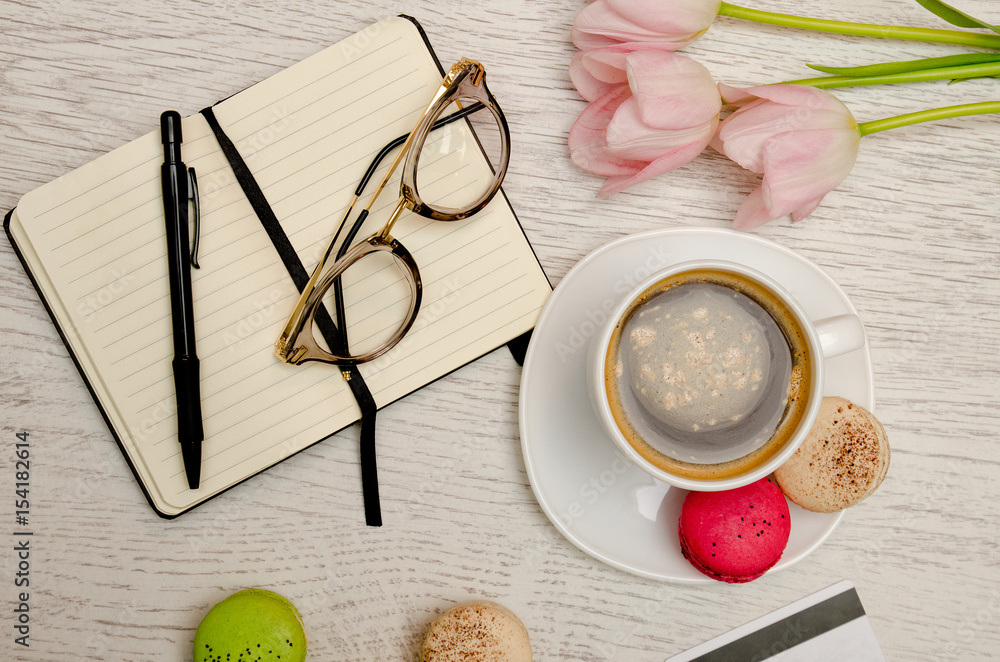 Planning of affairs. Coffee mug with dessert, notebook, pen and glasses. Planning of affairs. Coffee mug with dessert, notebook, pen and glasses.