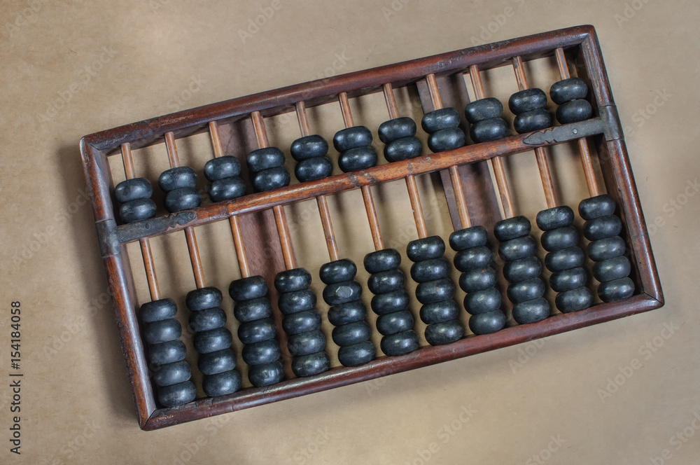 Chinese abacus or counting frame on bright brown background Chinese abacus or counting frame on bright brown background