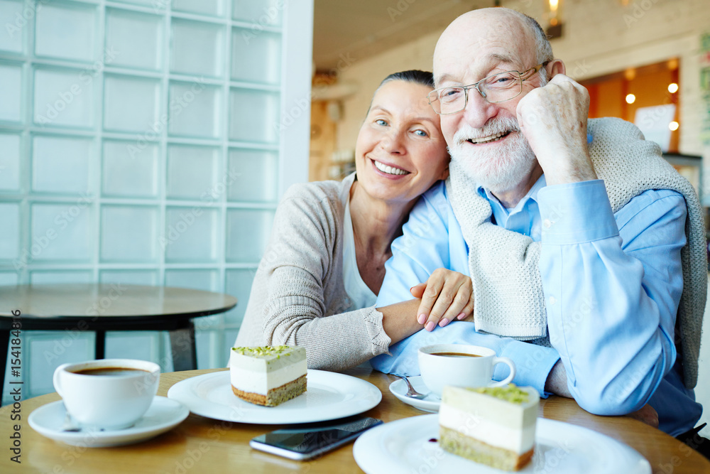 Affectionate seniors sitting in cafe Affectionate seniors sitting in cafe