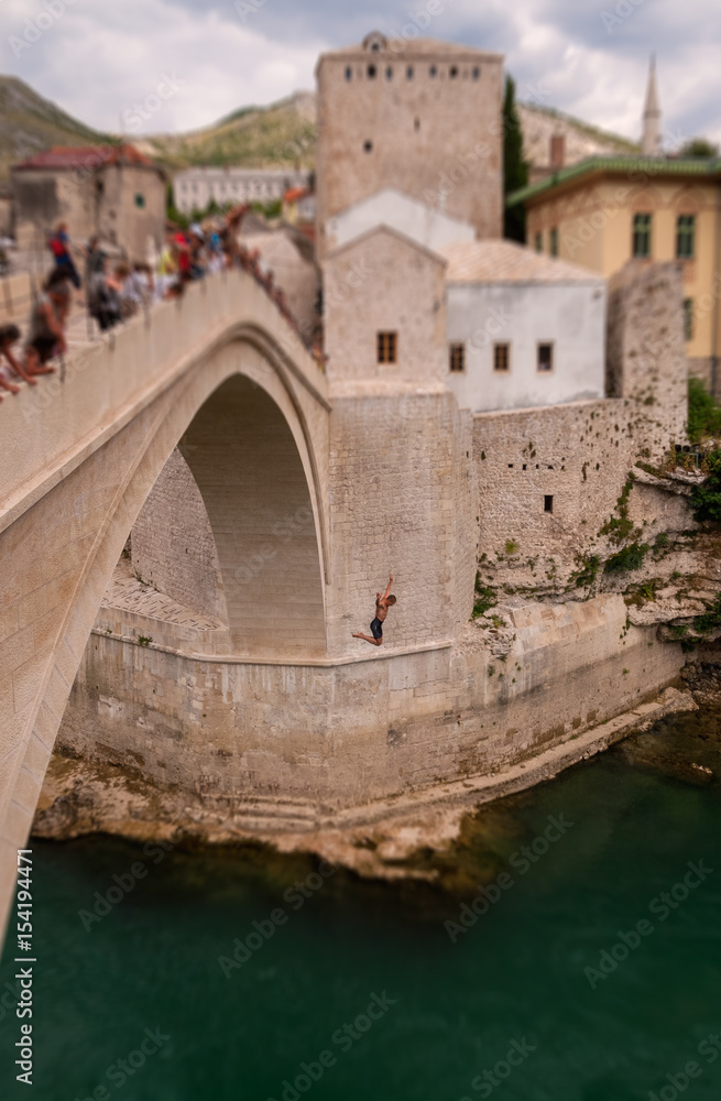 man jumping from Old Bridge in Mostar