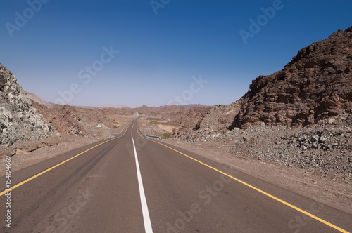empty road through dry rocky hills