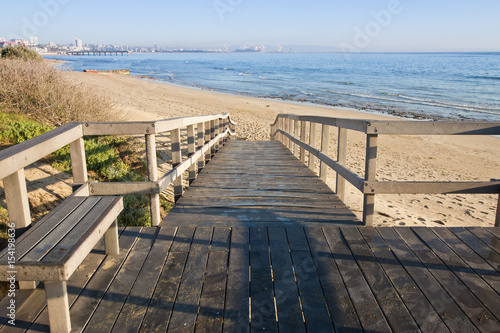 Wooden walkway onto a beach © bondsza