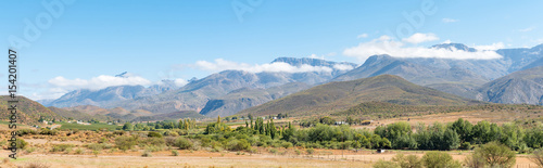 Panorama of farm landscape with Swartberg mountains near Hoeko
