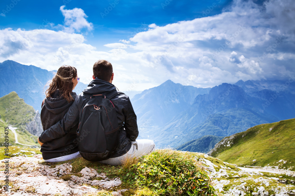 Fototapeta premium Couple of travelers on top of a mountain. Mangart, Julian Alps, Slovenia.