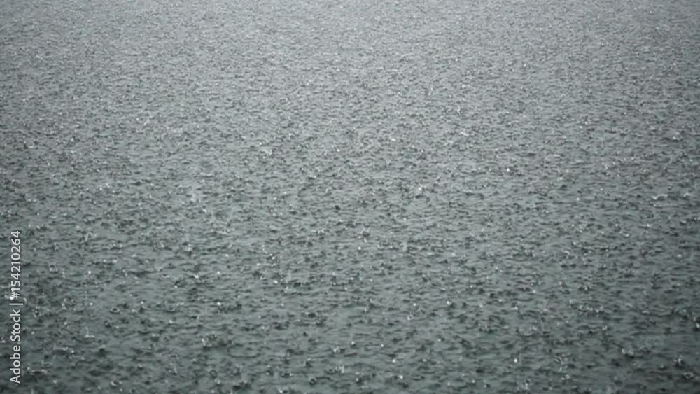 SLOW MOTION: Raindrops falling on water surface above, lost at sea drowning SLOW MOTION: Raindrops falling on water surface above, lost at sea drowning