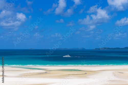 White cruise ship, boat on turquoise blue waters of Coral sea