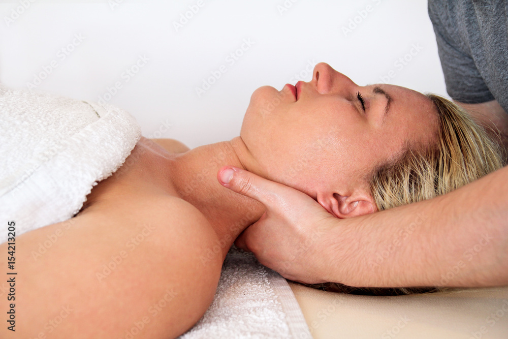 Massage relax studio. Woman taking a massage neck muscles at massage table. Body care. Spa body massage treatment.