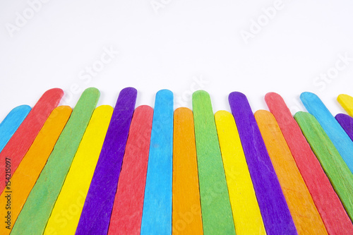 Colourful wooden sticks on white background