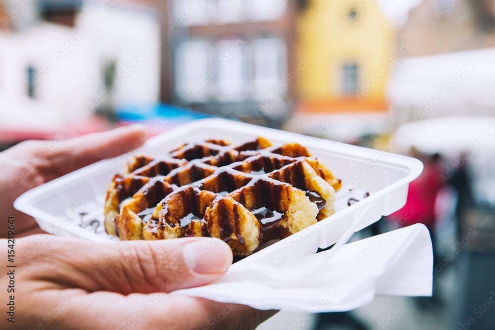 Fototapeta premium Traditional Belgian dessert, pastry - Belgium tasty waffle with chocolate sauce