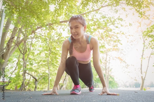 Young woman is running in sunny nature