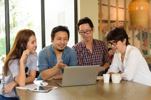 Smart handsome asian businessman explaining his project to asian Team group freelancer in casual suit at coffee shop cafe. Business and Office Concept.
