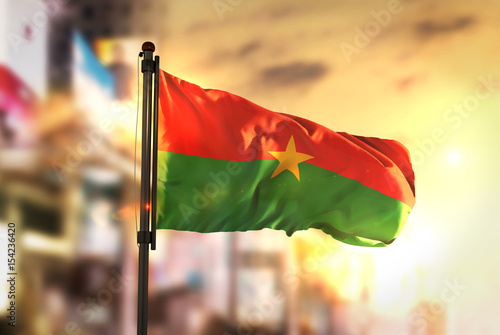 Принти на полотні Burkina Faso Flag Against City Blurred Background At Sunrise Backlight