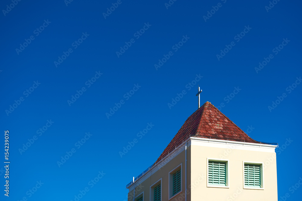 Steeple of a church against a clear blue sky