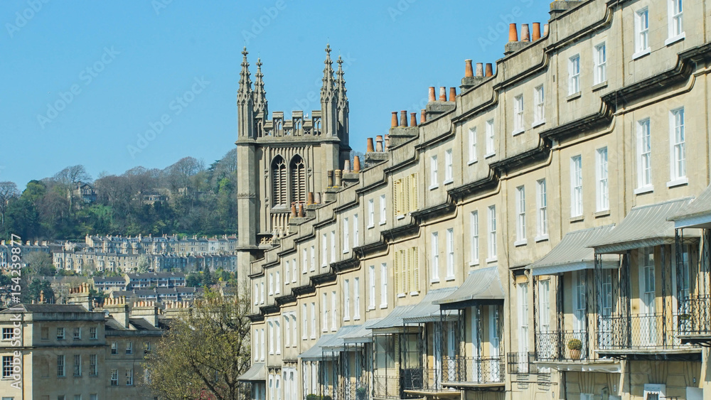 victorian townhouse or terrace in bath city in england united kingdom daytime down hill in a row brick style sunny day / victorian townhouse Bath in england