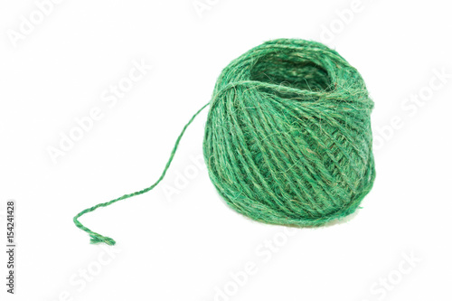Linen thread of green color on a white background