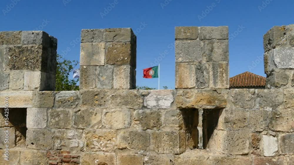 Portuguese flag behind the tower at Sao Jorge castle