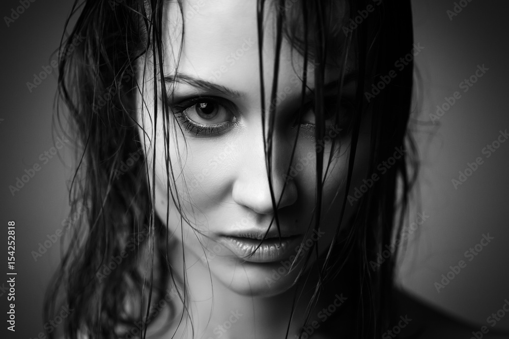 beautiful woman with wet hair looking at camera, monochrome