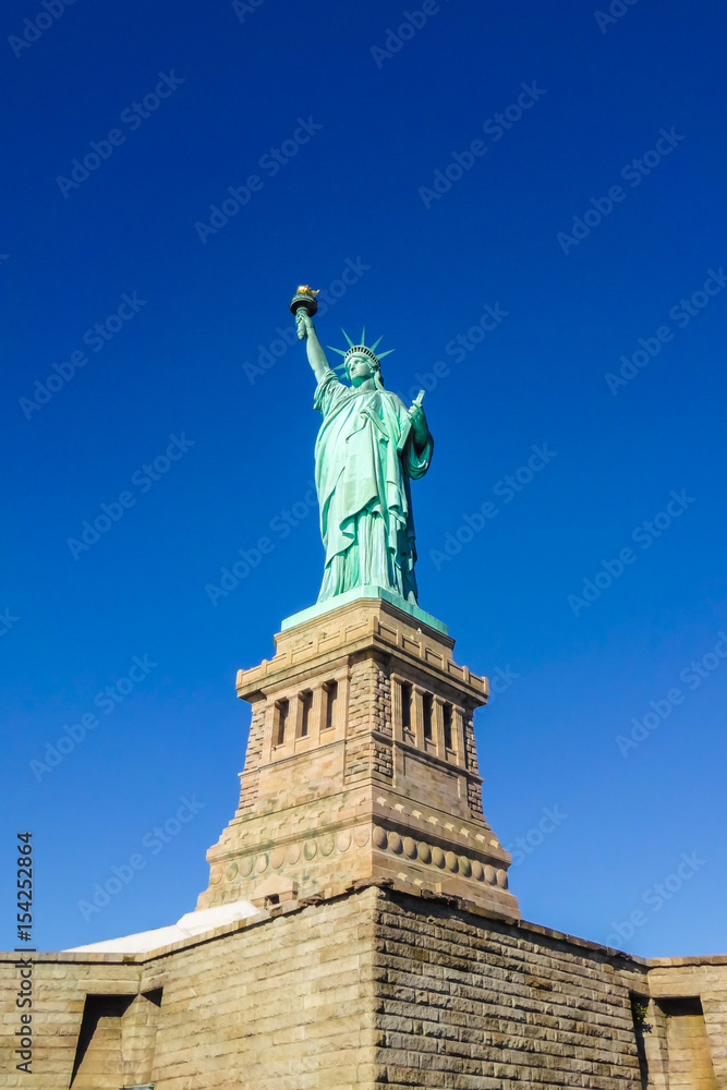 Statue of Liberty at perfect weather conditions blue sky copper torch