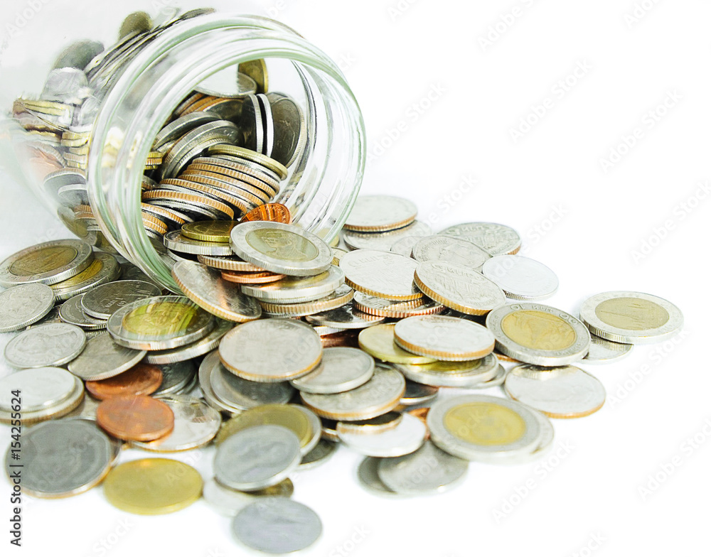 coins poured out of glass jar on white background for saving or financial concept coins poured out of glass jar on white background for saving or financial concept