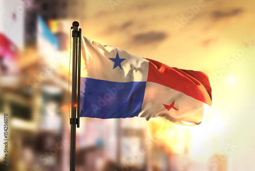 Panama Flag Against City Blurred Background At Sunrise Backlight