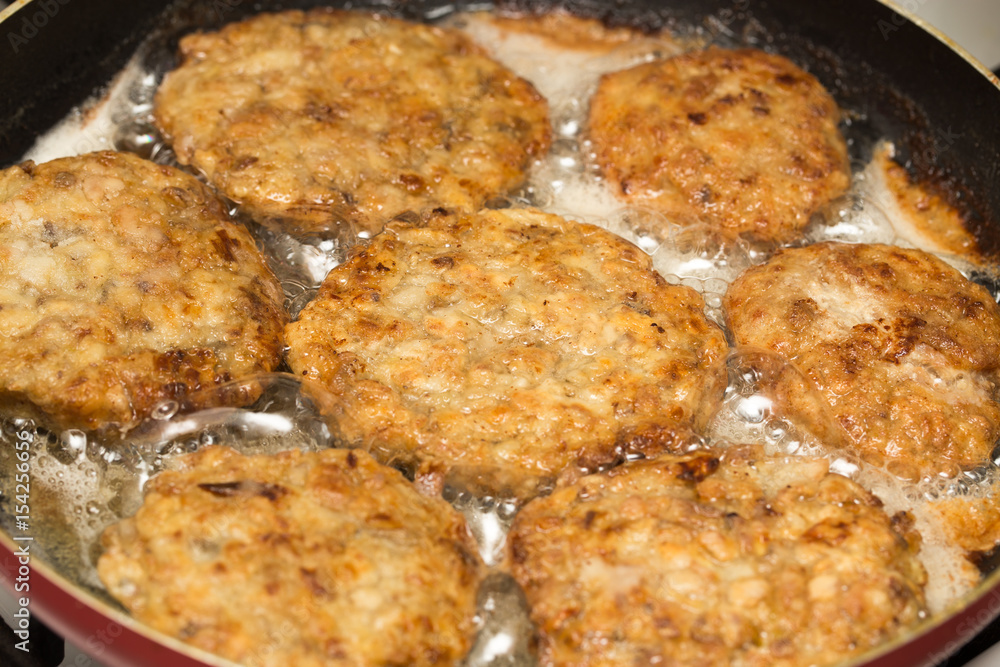 Meat patties are fried in a frying pan Meat patties are fried in a frying pan