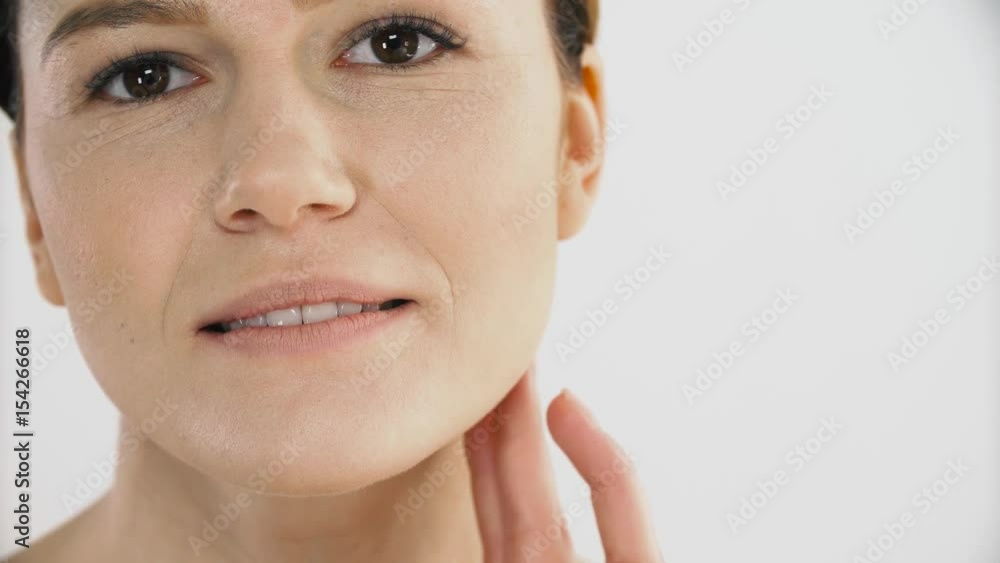 Skin Care. Mature Healthy Female Touching Face Skin With Hand Skin Care. Mature Healthy Female Touching Face Skin With Hand