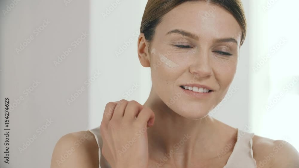 Beauty Face. Beautiful Woman Applying Liquid Foundation On Skin Beauty Face. Beautiful Woman Applying Liquid Foundation On Skin