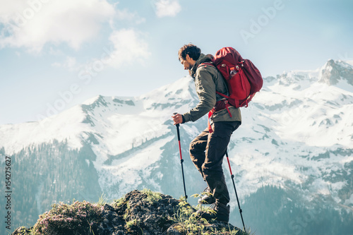 Fotografering Traveler Man climbing with backpack Travel Lifestyle concept active adventure su