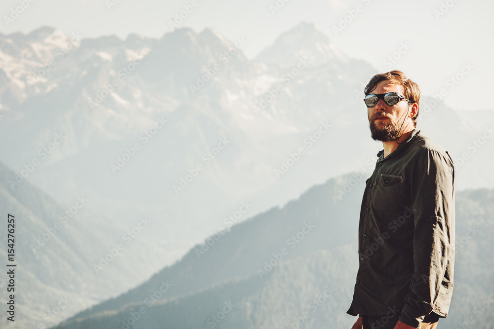 Man Traveler at mountains spending his vacations Travel Lifestyle concept adventure outdoor mountains landscape on background