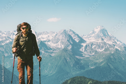 Hiker Man climbing mountains with backpack Travel Lifestyle concept adventure vacations outdoor rocky mountains landscape on background