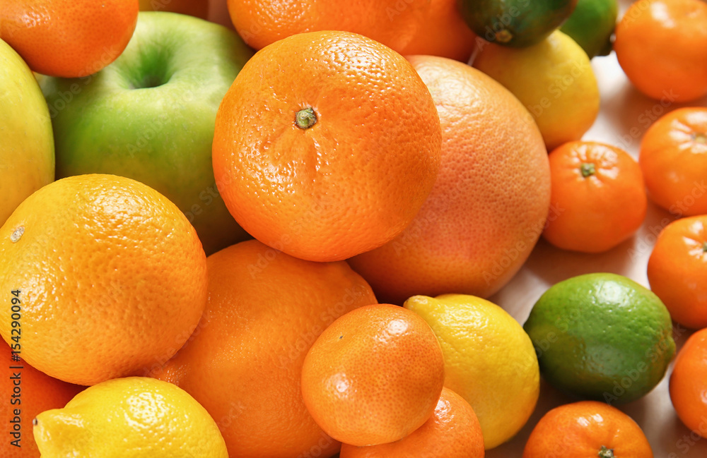 Heap of juicy citrus fruits and apple, closeup Heap of juicy citrus fruits and apple, closeup