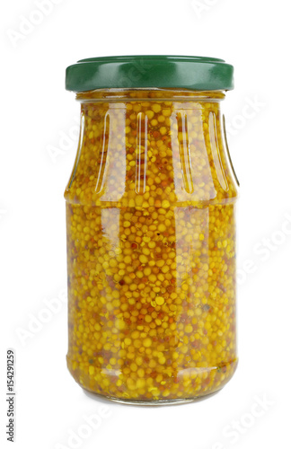Glass jar of french mustard isolated on white