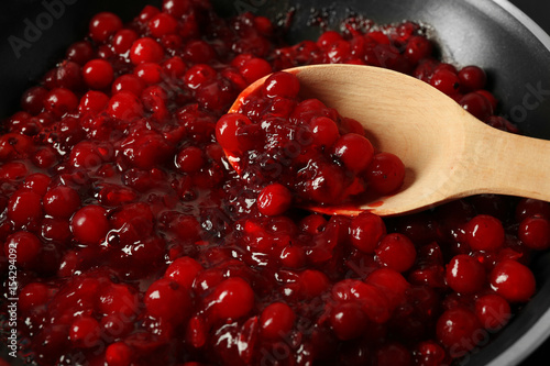 Delicious cranberry sauce in pan close up