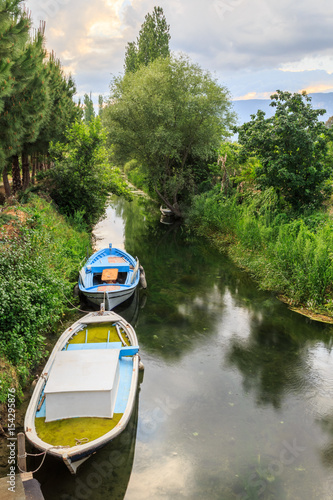 Boat in the river in Akcapinar, gokova, Turkey photo