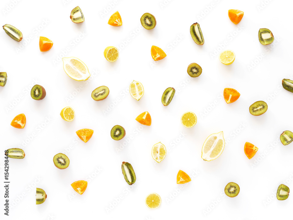 Fruit pattern. Cut fruit on a white background. Citrus in the cut. Food background. Composition of fruits oranges, lemons, kiwi. Fruit pattern. Cut fruit on a white background. Citrus in the cut. Food background. Composition of fruits oranges, lemons, kiwi.