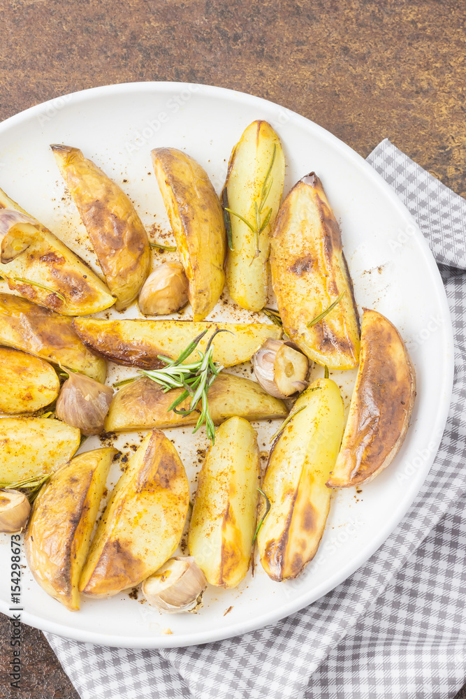 Oven roasted rosemary garlic potatoes. Top view. Stock Photo Adobe Stock