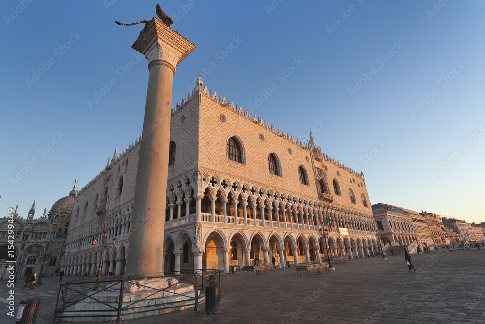 Two symbols of Venice: winged St Mark Lion on its column and Doge's palace at sunrise, Italy, Europe