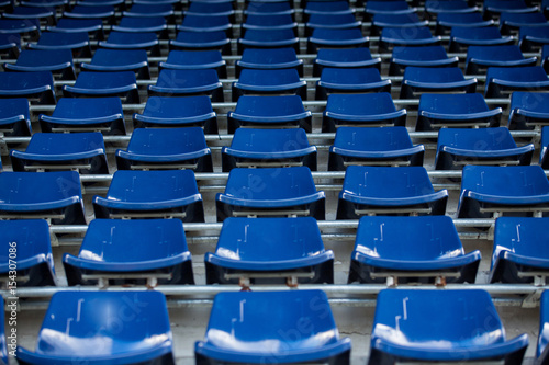 Rows of blue plastic stadium seats.
