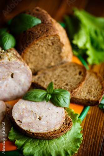 A sandwich with homemade sausage and rye bread